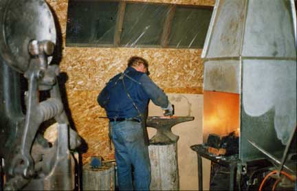 In earlier years: Brian Lyttle using his coal forge to forge Damascus steel