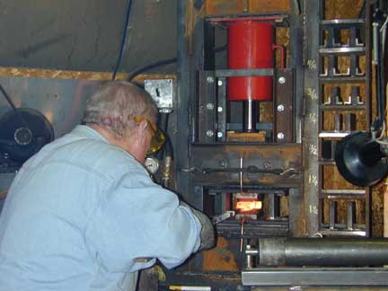 Brian Lyttle using his hydraulic press to forge Damascus steel